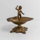 Vintage brass ashtray from the 1940s with a nude boy figurine on a footed base.