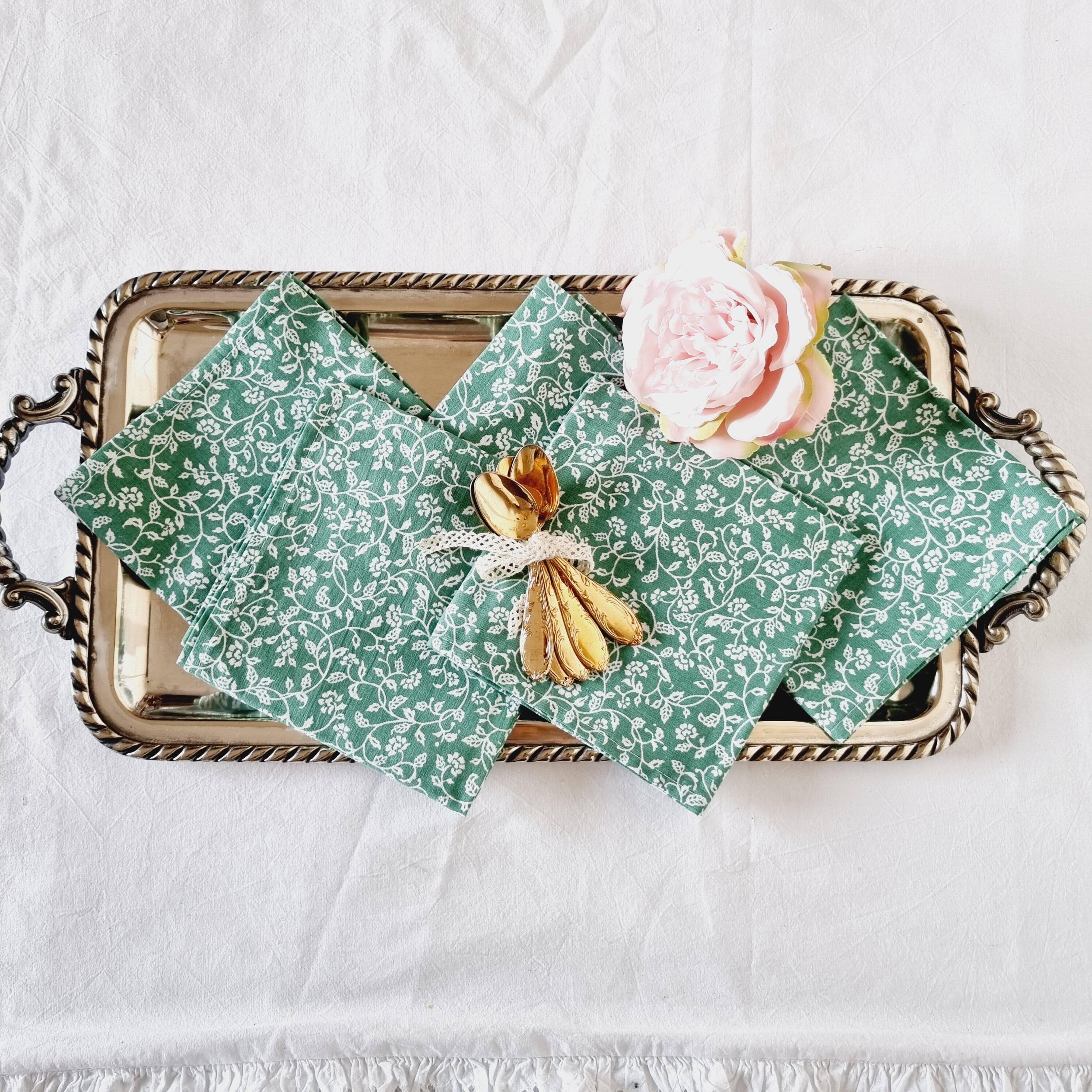 6 green cotton cloth napkins with white linens