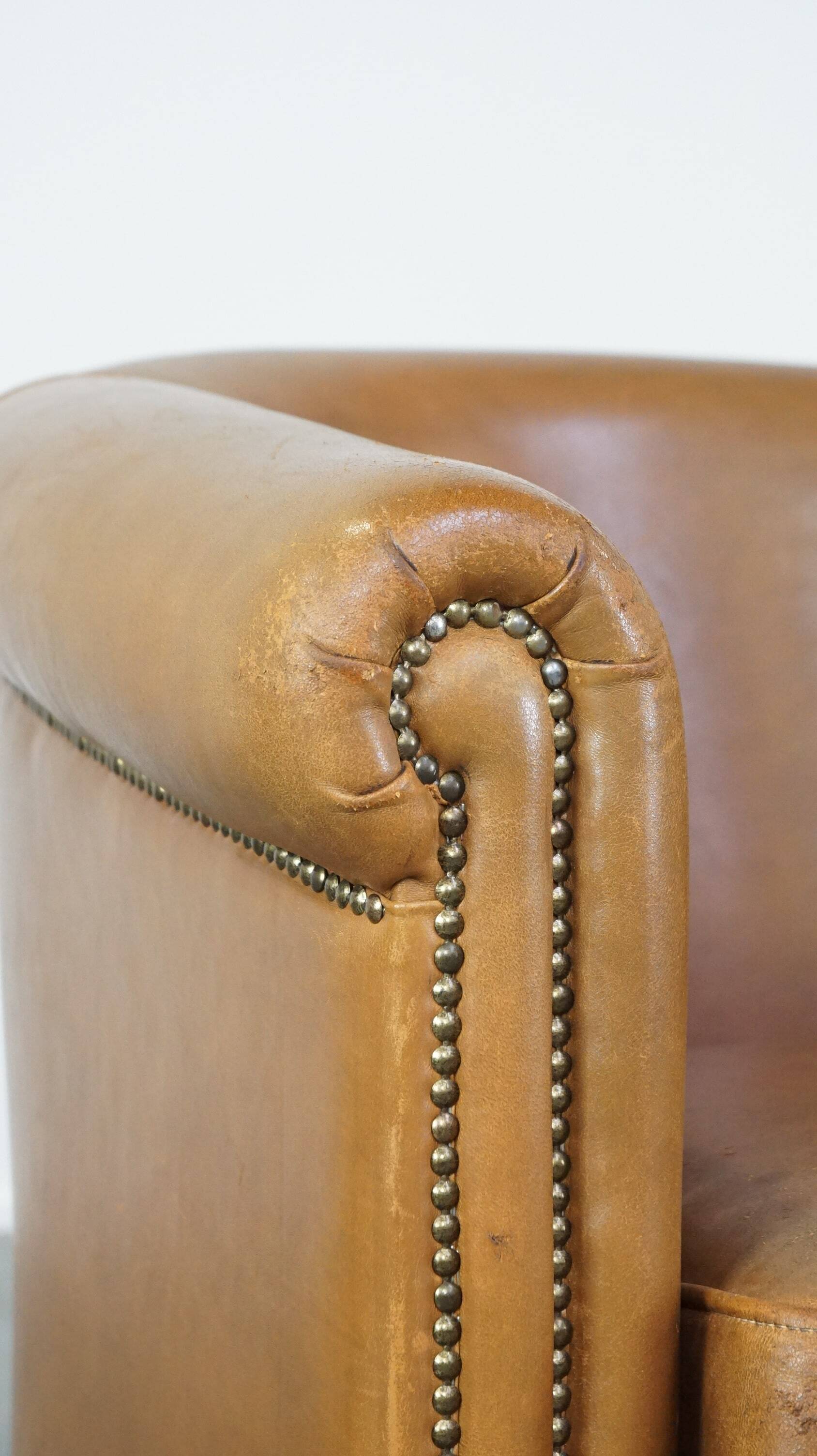 Sheep leather club chair in neutral cognac colour and in good condition