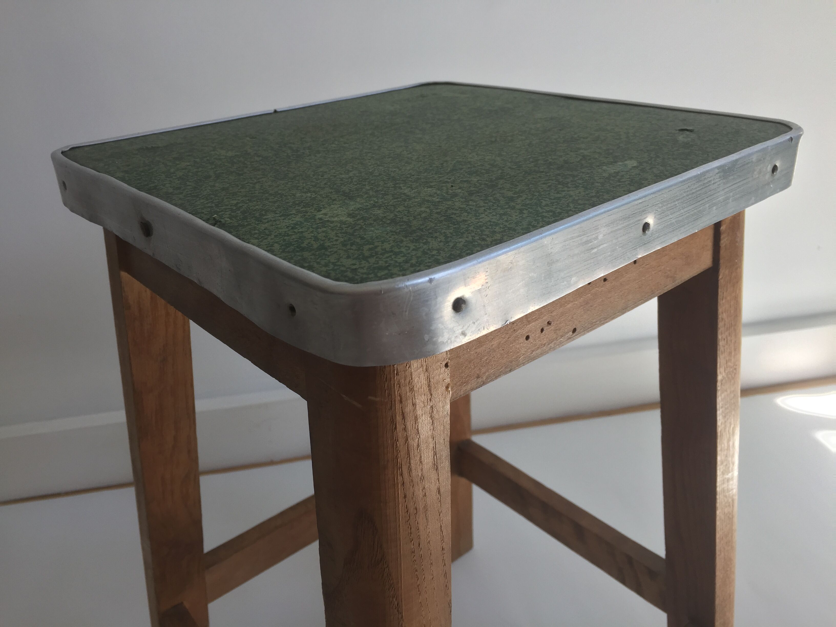 Wooden stool and green seat