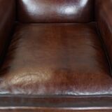 Comfortable and correct dark antique sheepskin English armchair in very good condition