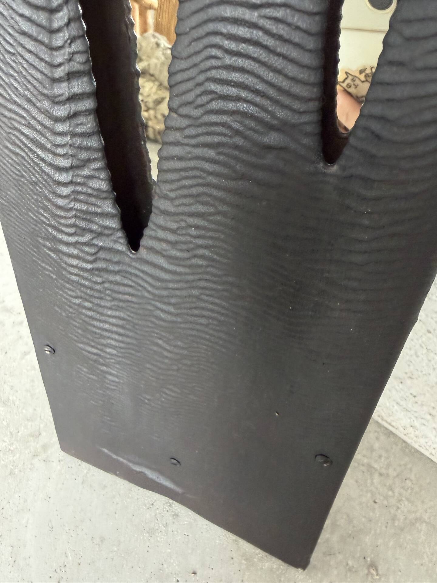 Brutalist hammered mirror, free-form, patinated metal.
