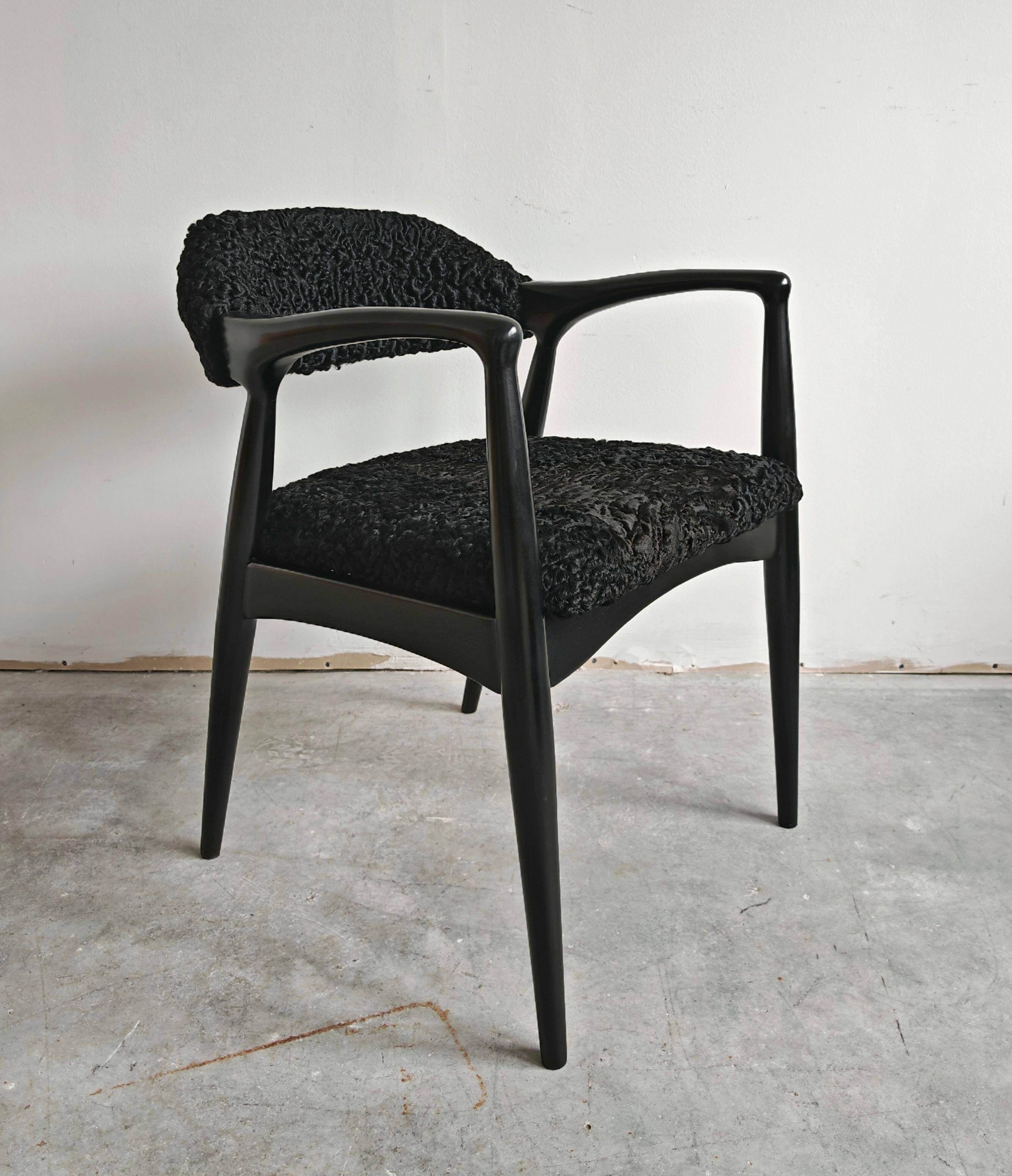 Pair of Mid Century Modern armchairs in astrakhan leather.
