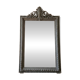 Antique mirror with a sculpted pediment in classic grey style.
