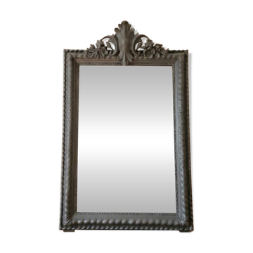 Antique mirror with a sculpted pediment in classic grey style.