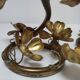 Pair of brass candle holders decorated with patinated metal flowers