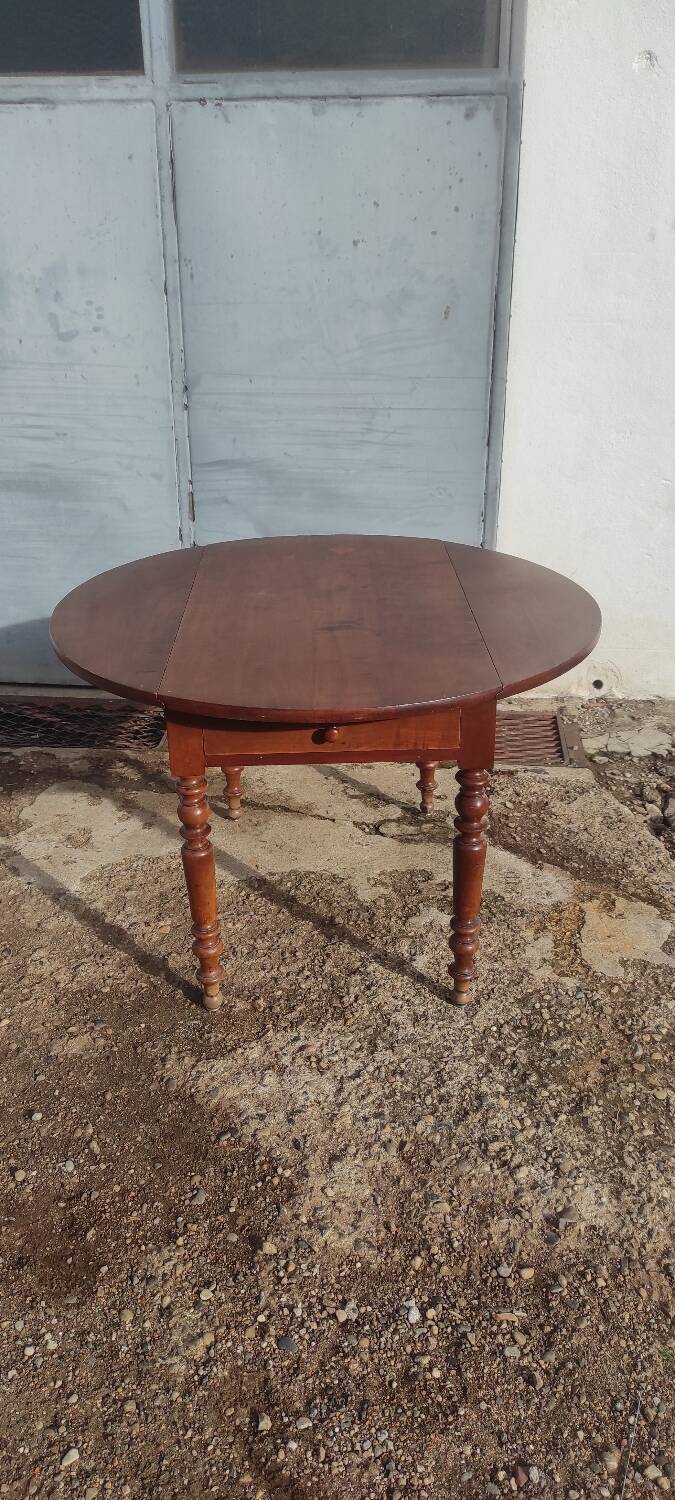 Old extendable round table in fruit wood with folding sides