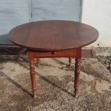 Old extendable round table in fruit wood with folding sides