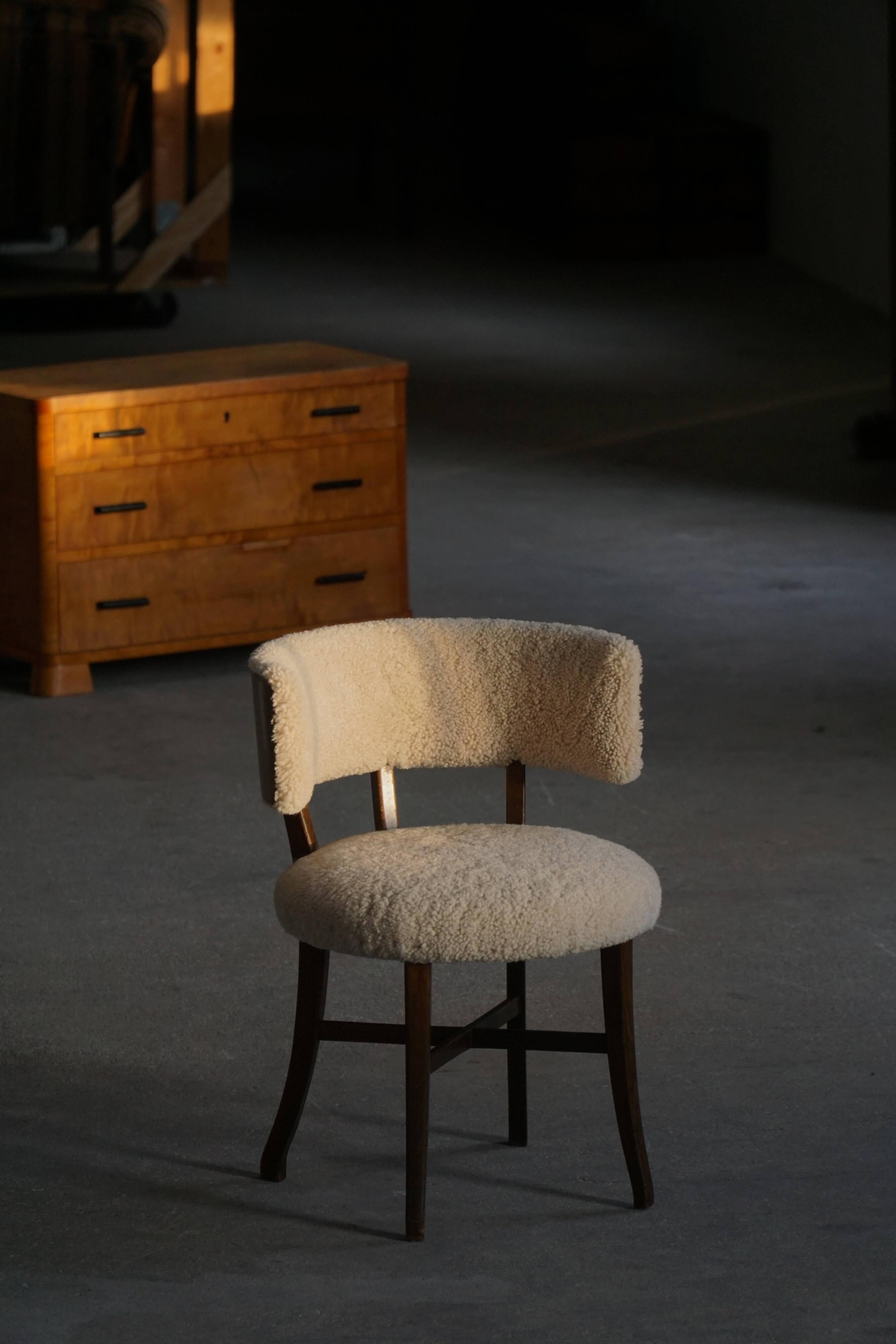 A modern Danish elegant low-back chair, reupholstered in lambswool, 1940s.