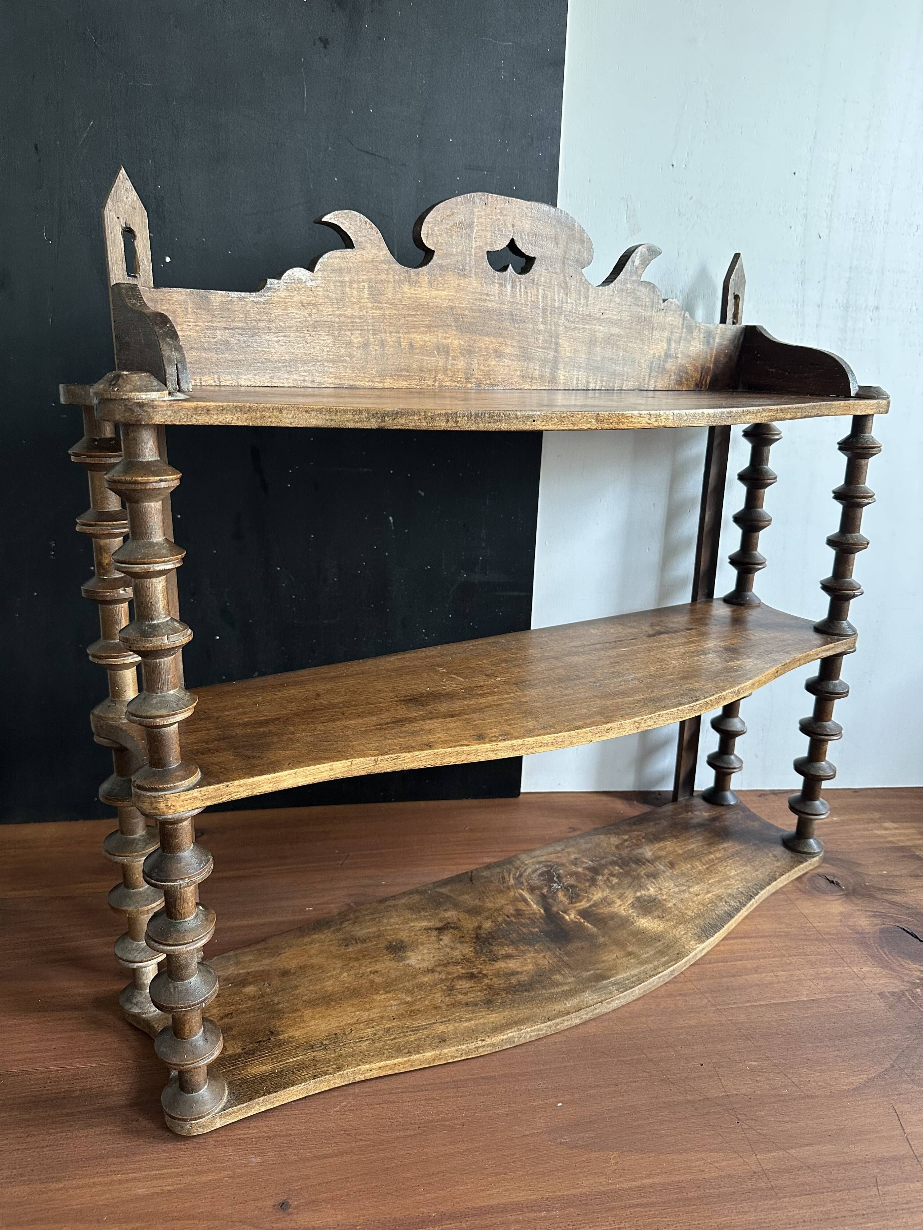 Antique wall shelf made of turned wood and spools of thread, late 19th century.