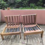 Pair of solid wood and leather lounge chairs, European work, circa 1970.