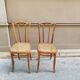 Pair of vintage bistro chairs in curved wood and caning.