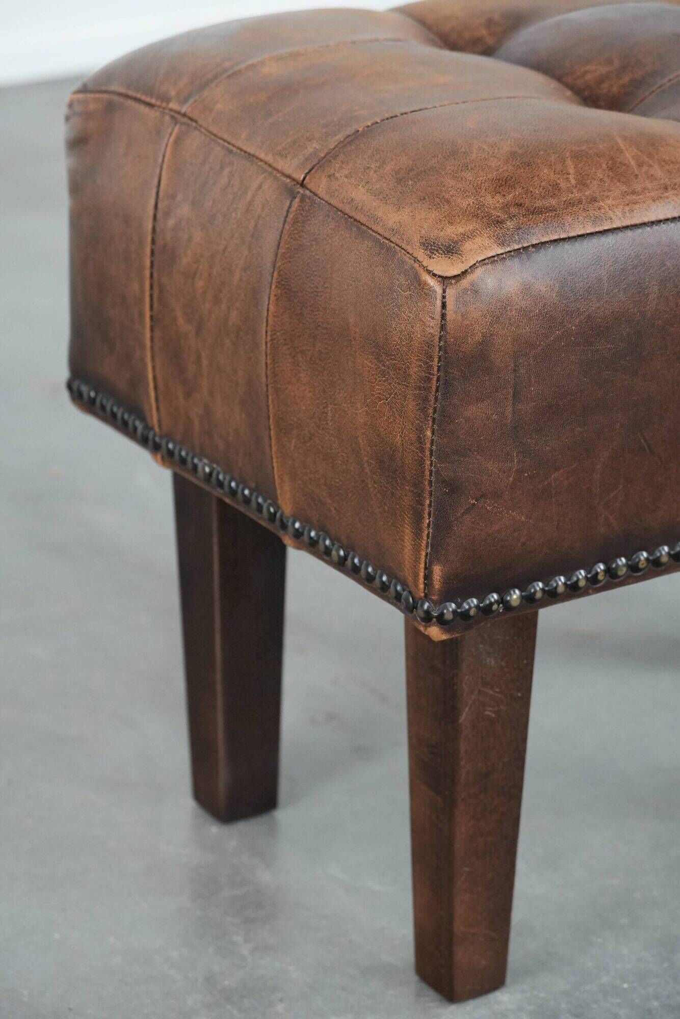 Beautiful sheepskin ottoman on high legs and beautiful warm colours