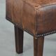 Beautiful sheepskin ottoman on high legs and beautiful warm colours