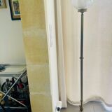 Floor lamp in gilded brass and round glass globe