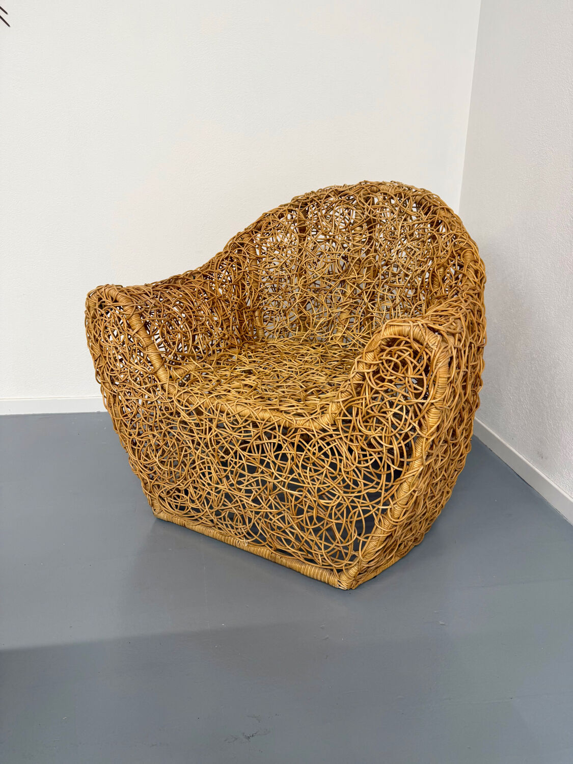 Sculptural woven rattan armchair, organic design from the 1970s.