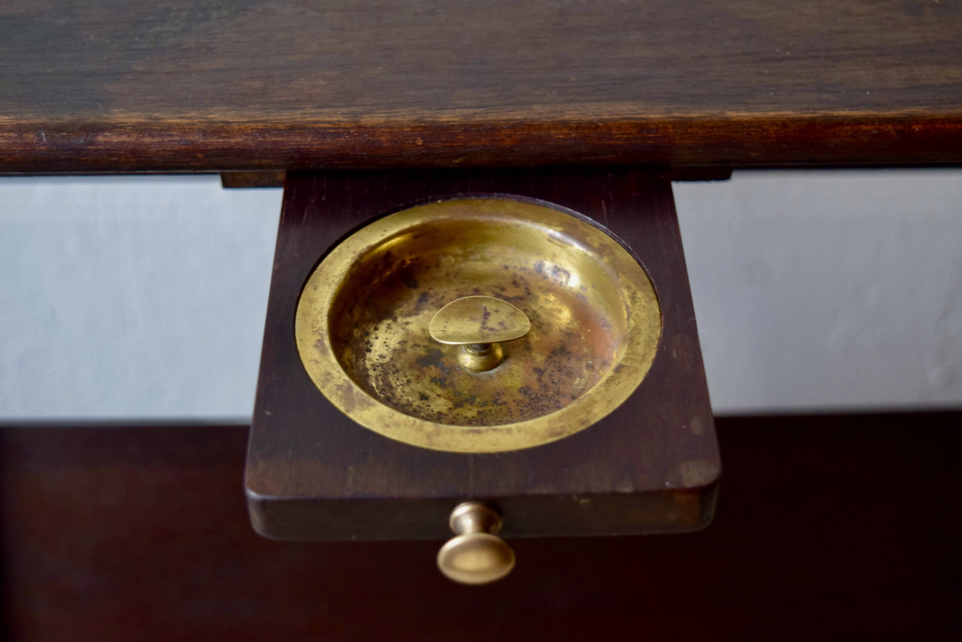 Old Scandinavian style magazine rack in dark wood with integrated brass ashtray