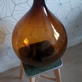 Great old demijohn in amber glass