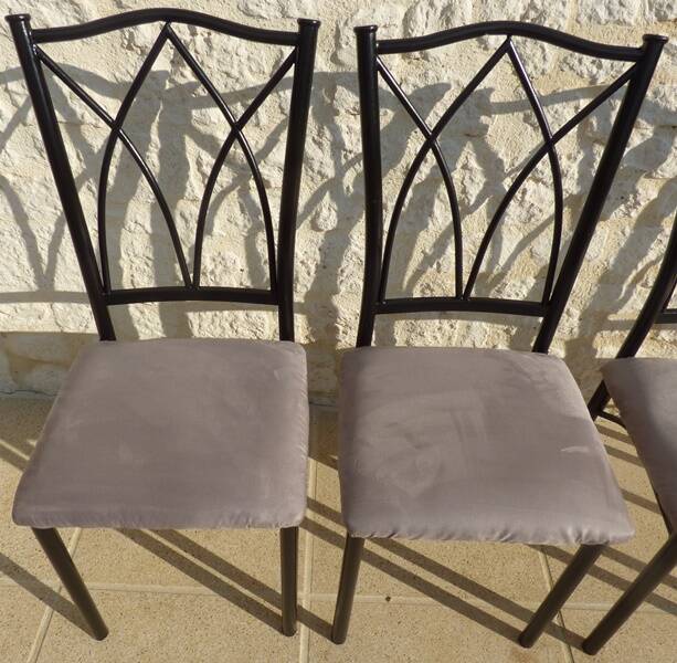 4 black metal chairs with high backs and gray suede tops