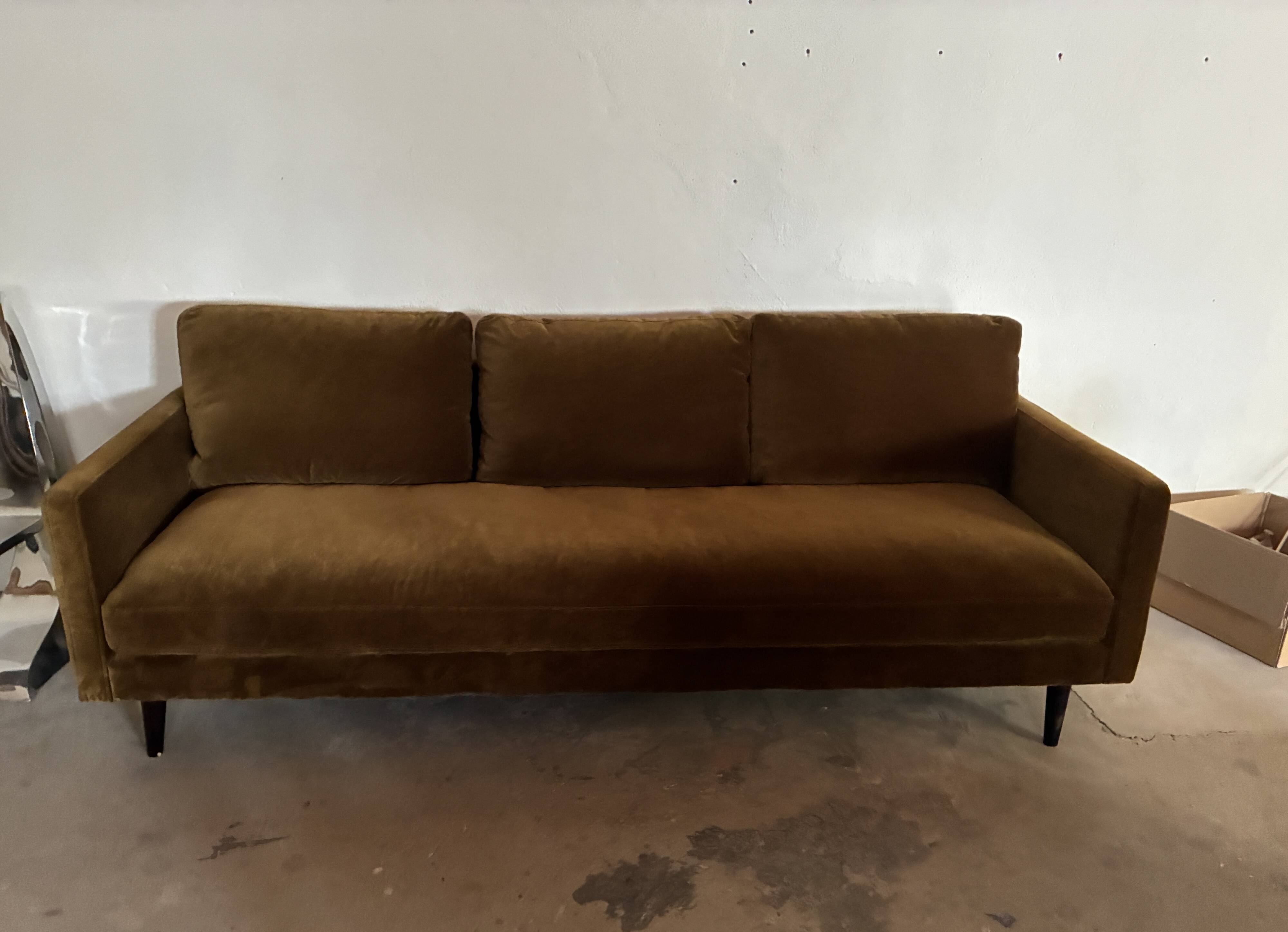 Large velvet three-seater sofa