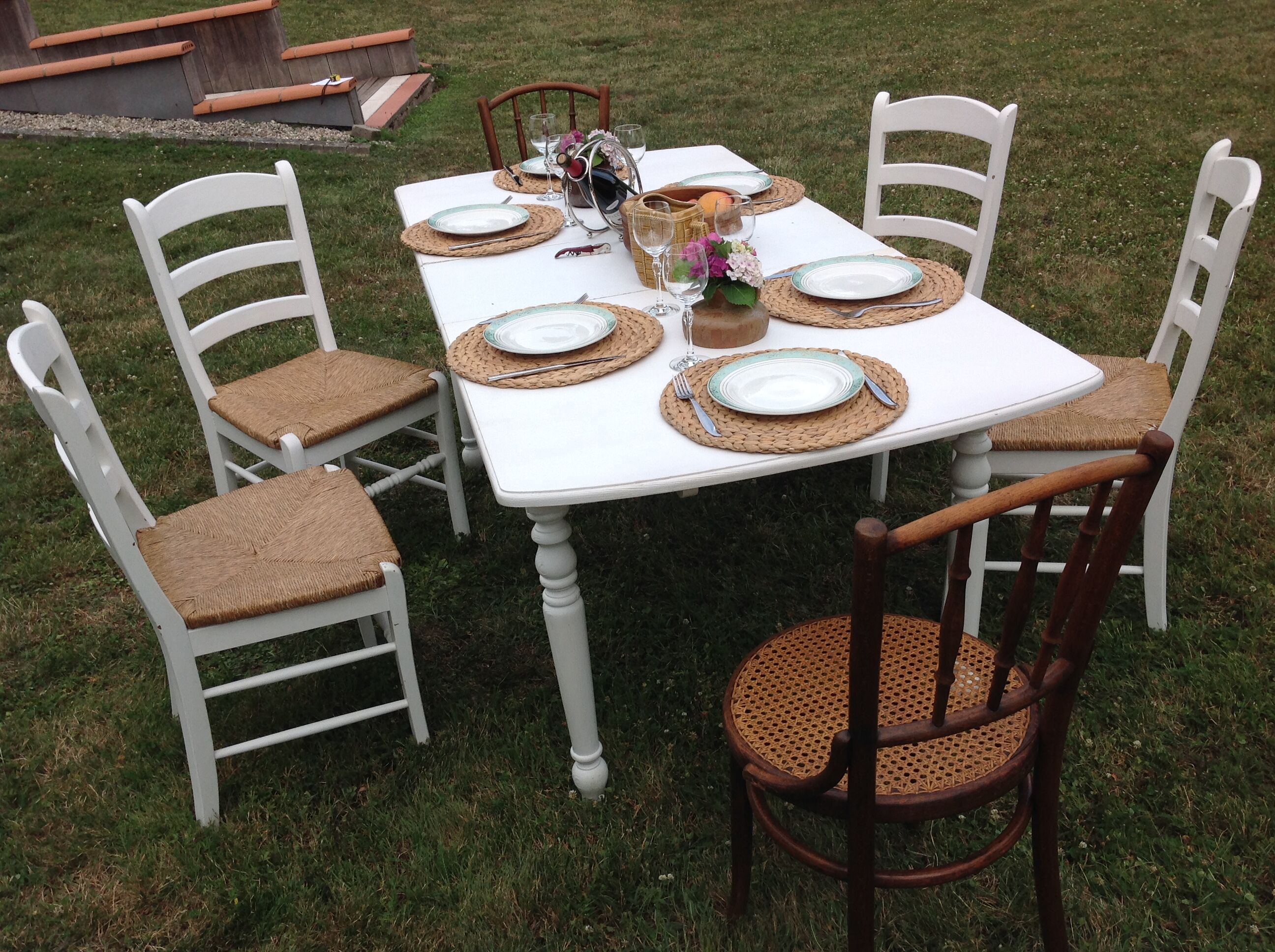 White farmhouse table set and four chairs