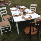White farmhouse table set and four chairs