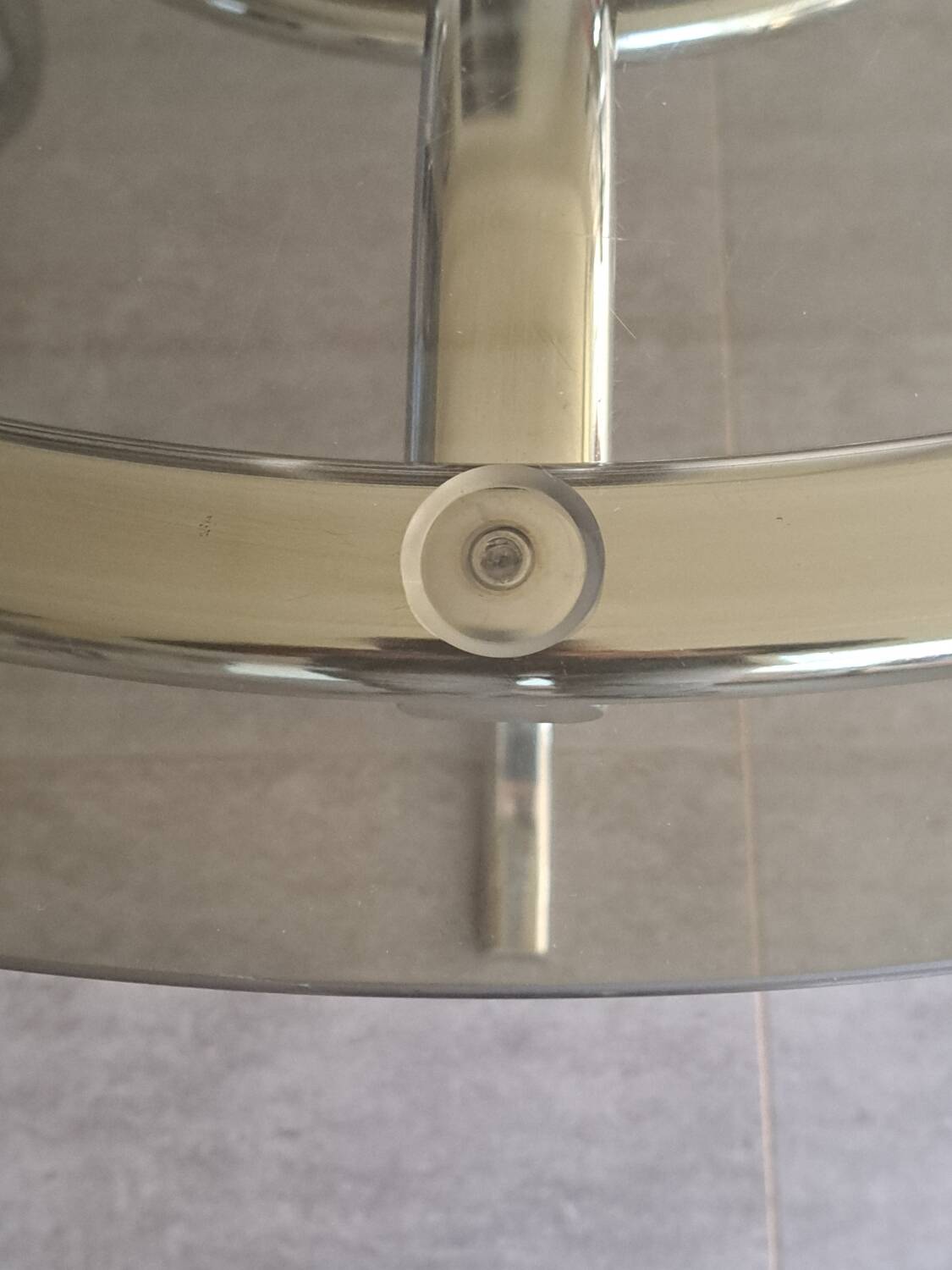 Round table in chromed metal and smoked glass