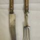Table art: a meeting of two sets of silver-plated cutlery.