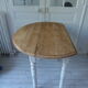 Oval table with beaded grey patinated flaps, wooden tray