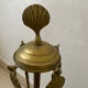 Vintage brass fireplace tool set with shell decoration.