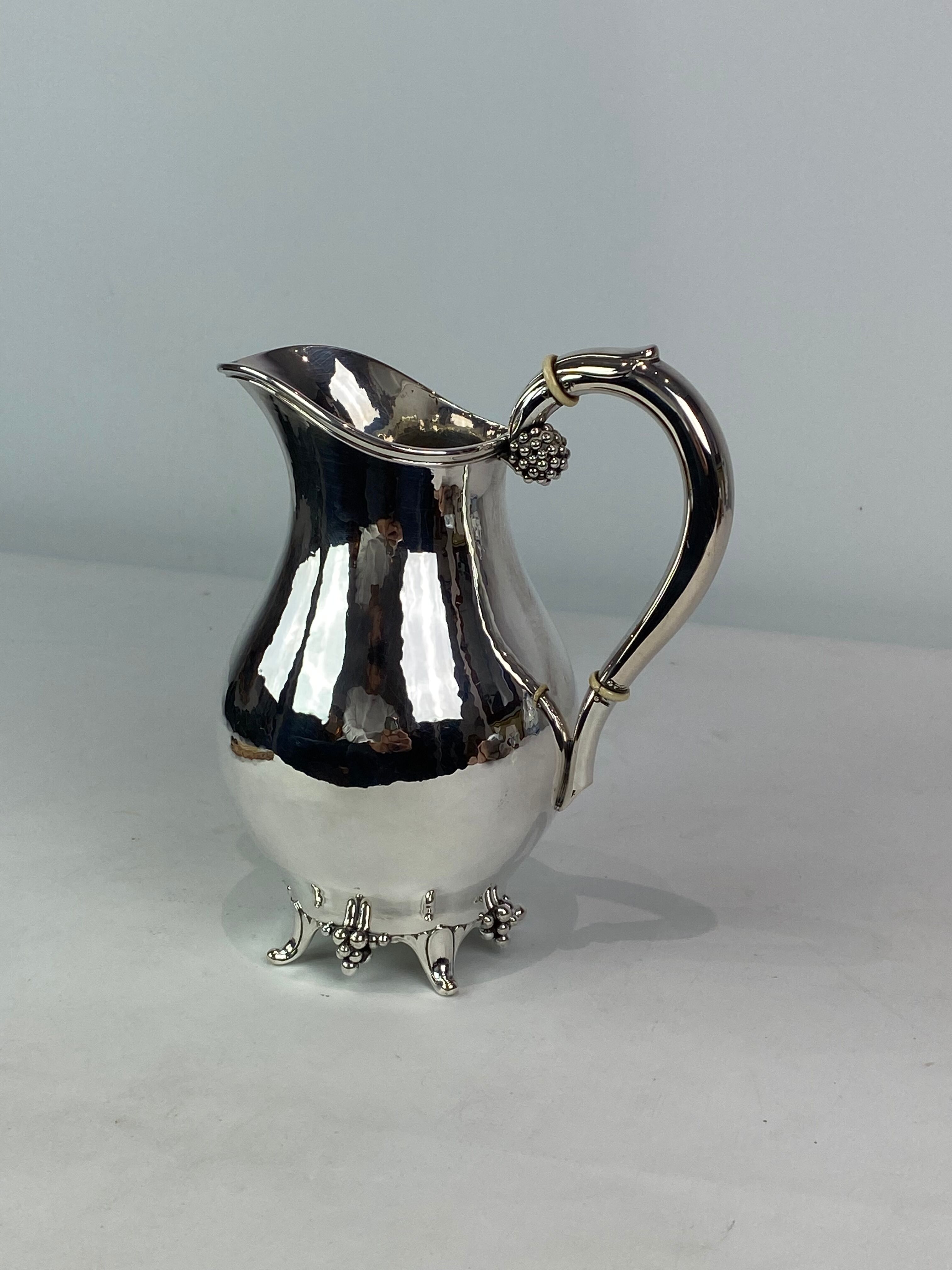 Water jug on feet decorated with ebony of hallmarked silver from the 1940s. The jug is in great anti