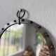 Brutalist round mirror with wrought iron and studs.