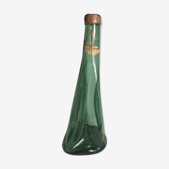 Old green molded glass bottle with rounded shape