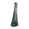 Old green molded glass bottle with rounded shape