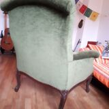Old green velvet armchair