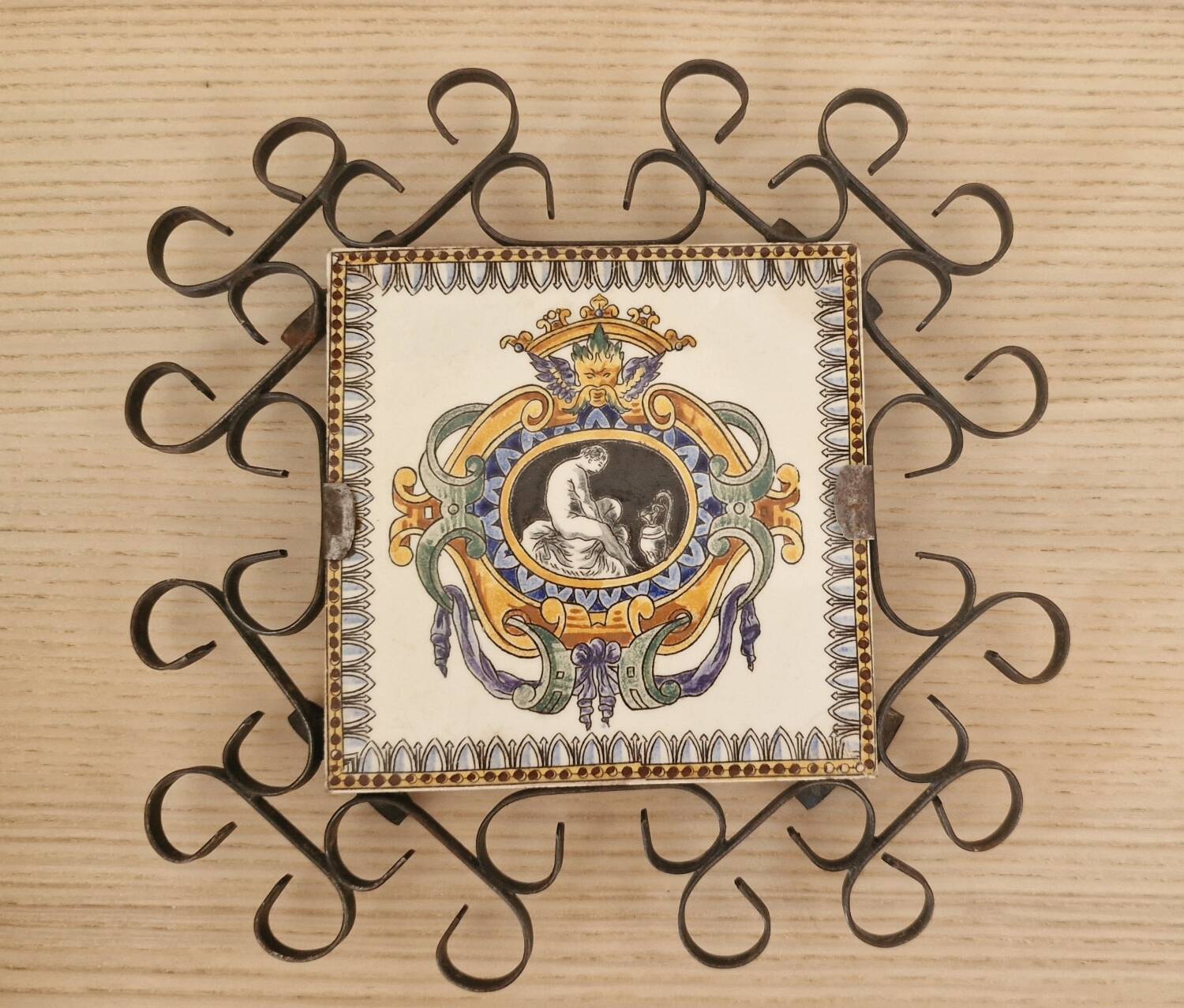 Hand painted gien tile on wrought iron trivet