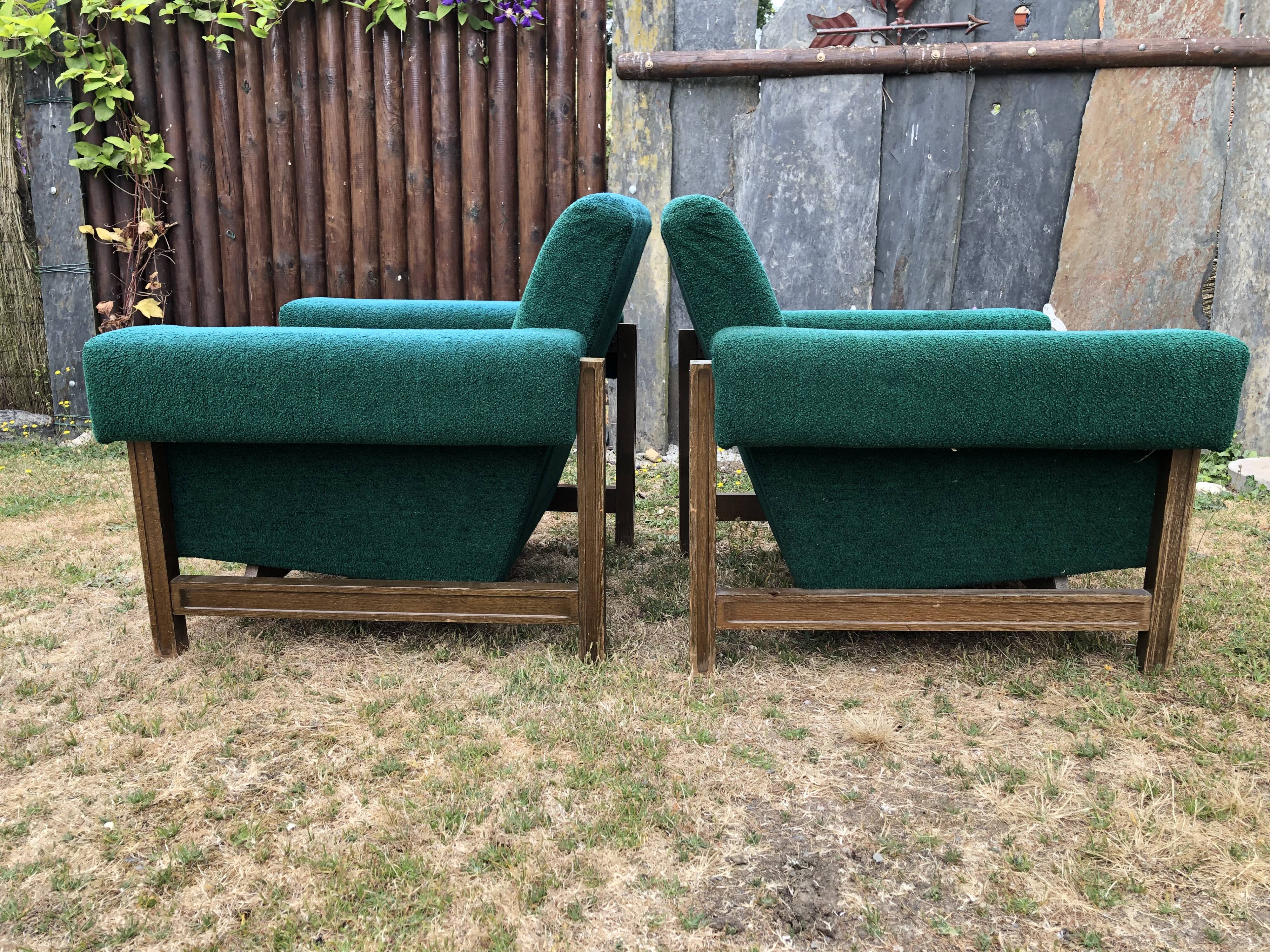 Duo of vintage armchairs with green fabrics.