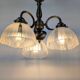 Antique Art Deco chandelier with 3 arms in patinated metal and ribbed glass.