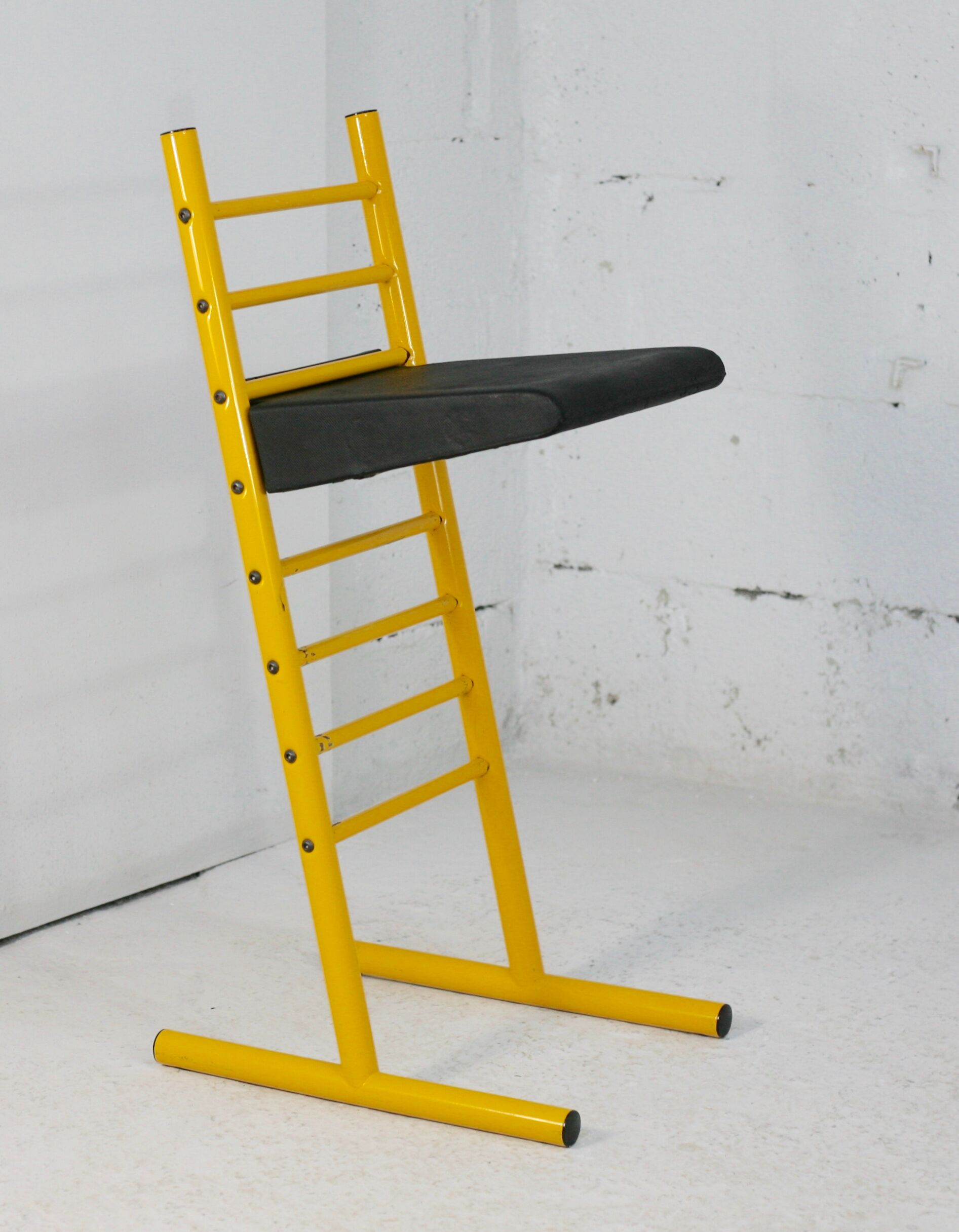 Adjustable seat chair. Circa 1980. Italy. Yellow lacquered steel.