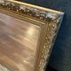 Antique mirror with a wooden and gilded stucco frame.