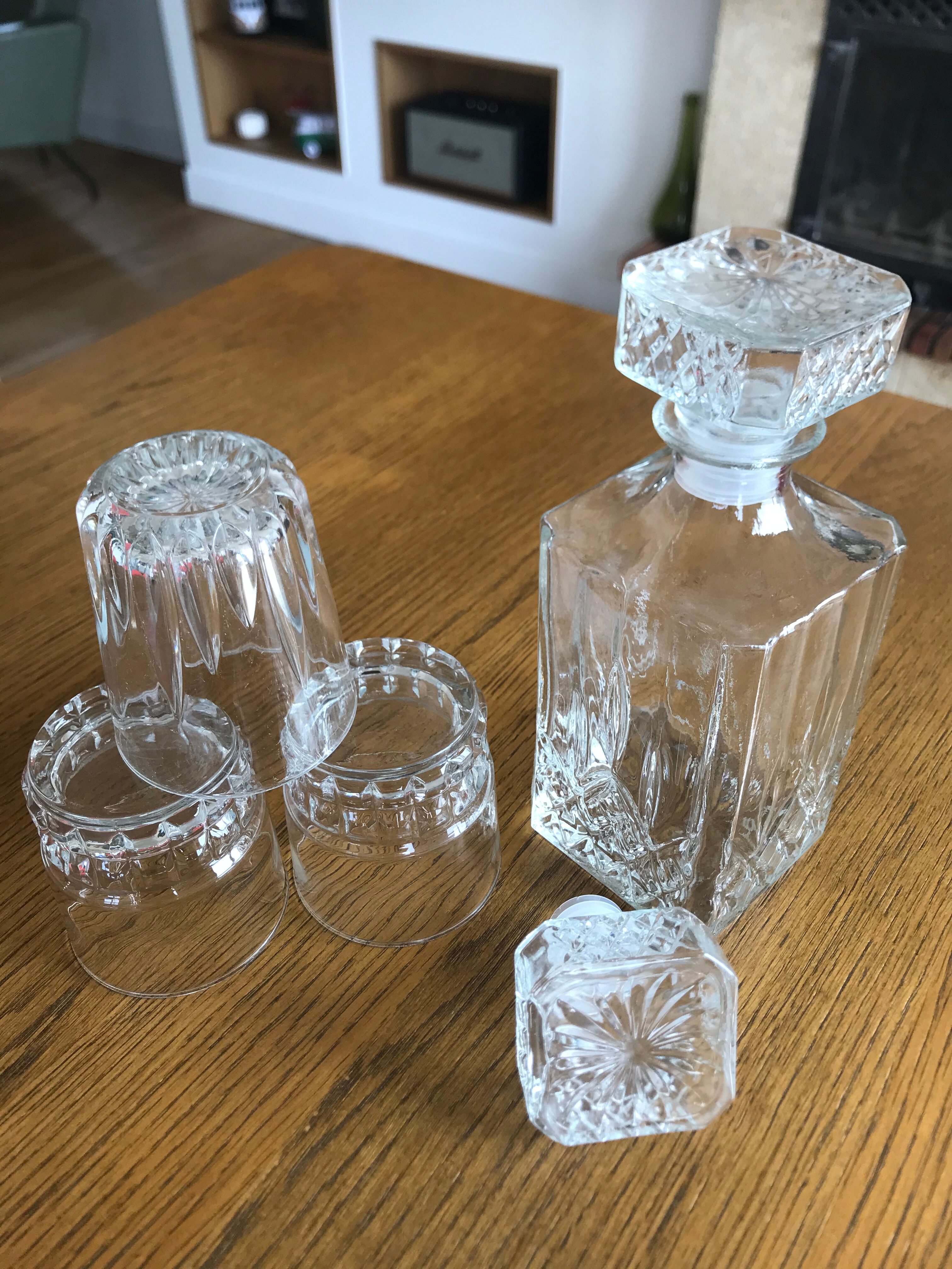 Mismatched decanter and whiskey glasses