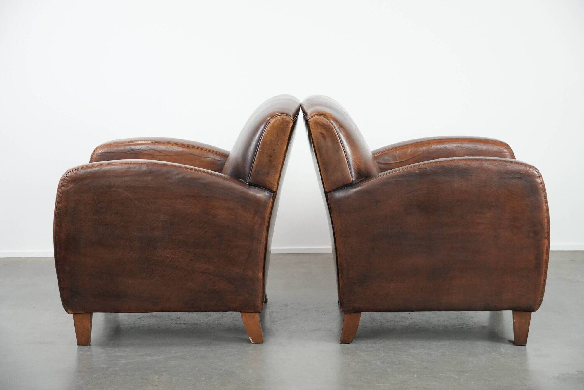 Characterful set of two vintage sheepskin armchairs with beautiful colours