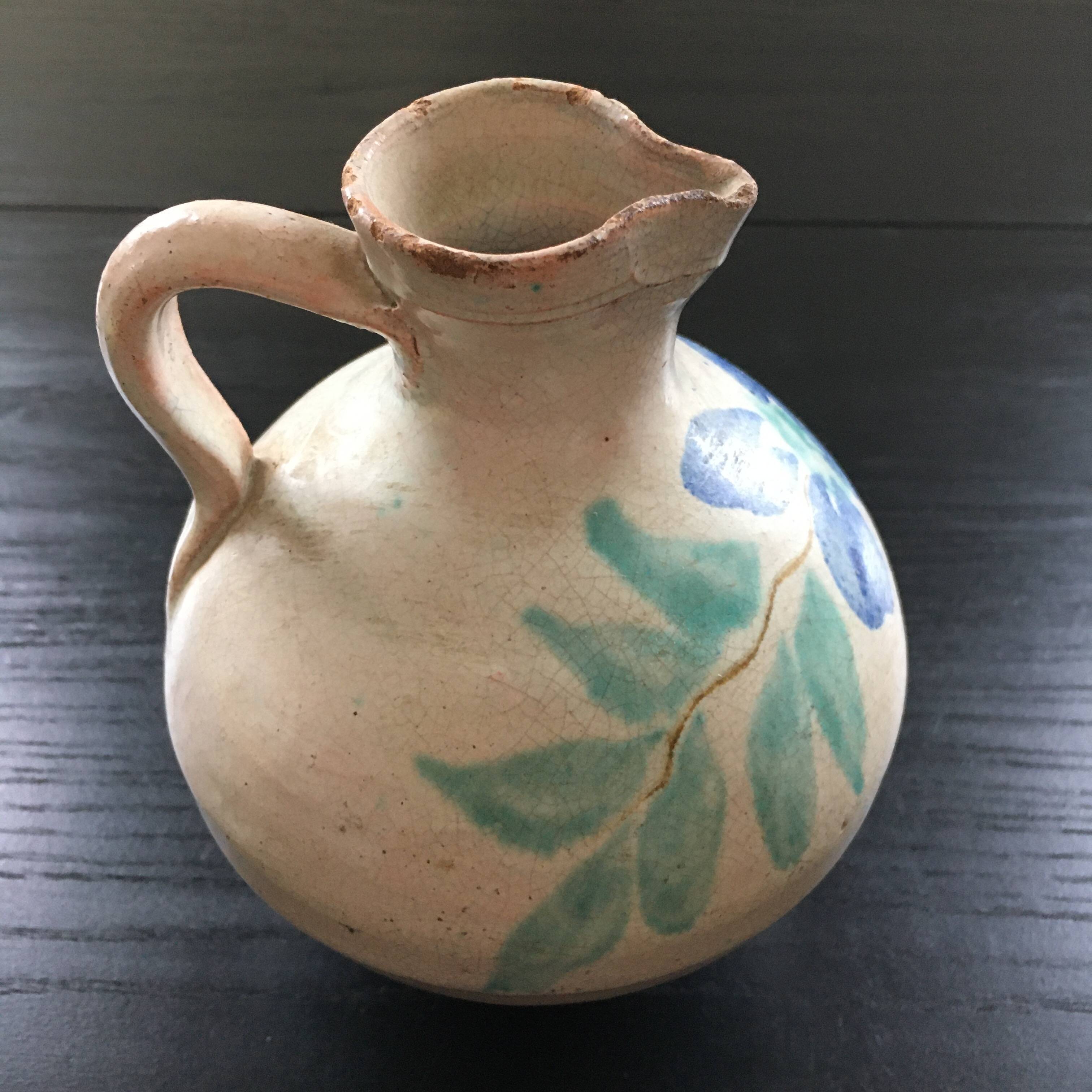 Antique pitcher with floral decoration