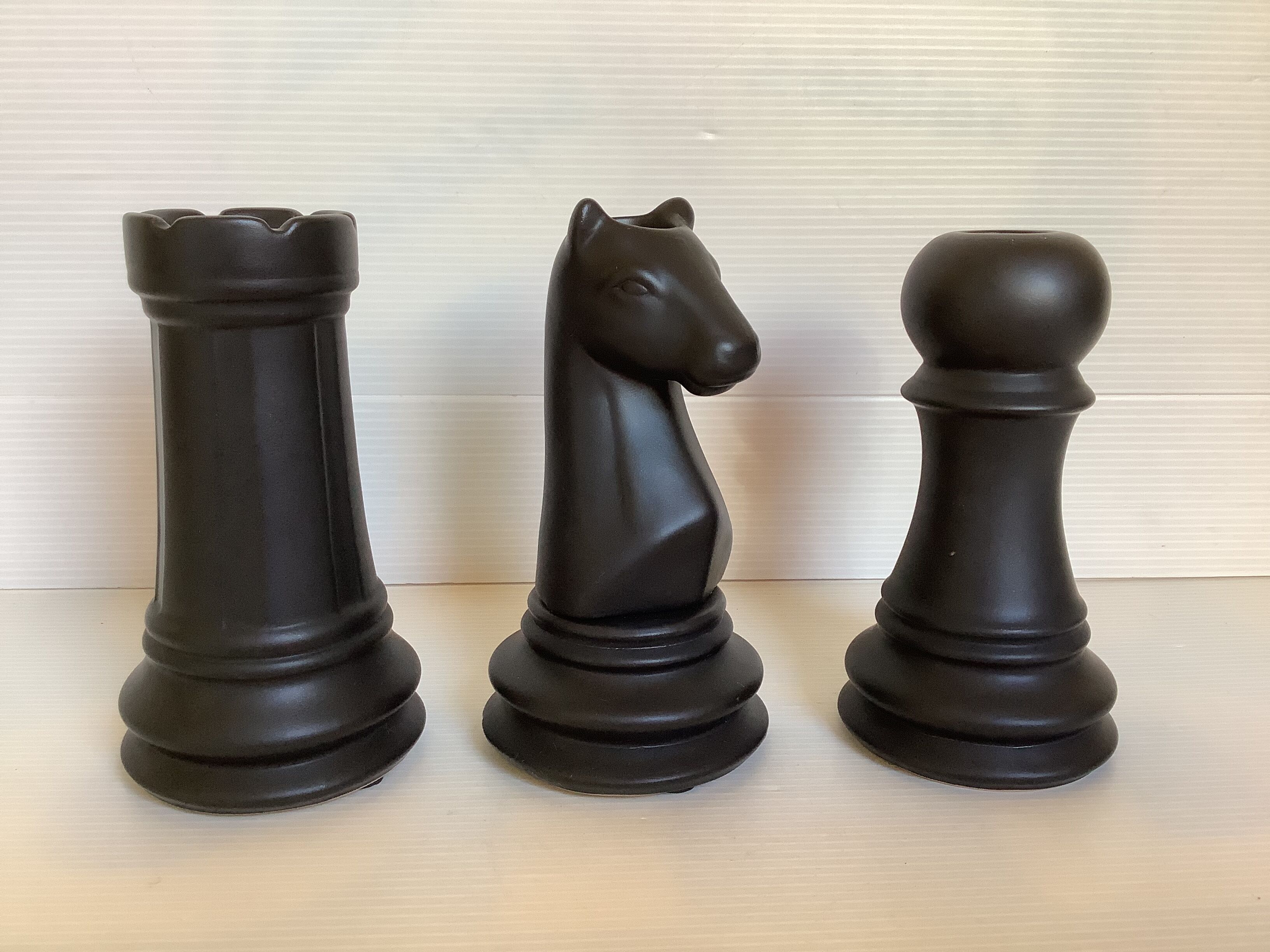 Trio of chess game candlesticks, rook, knight, pawn