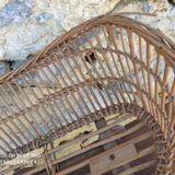 Old rattan cradle on wheels