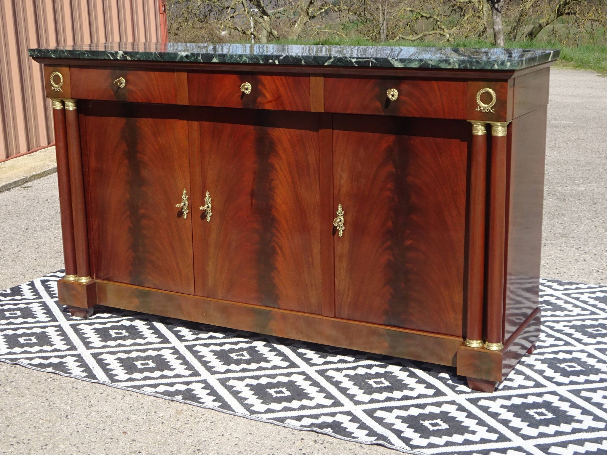Flamed mahogany enfilade with sea green marble in Empire style.