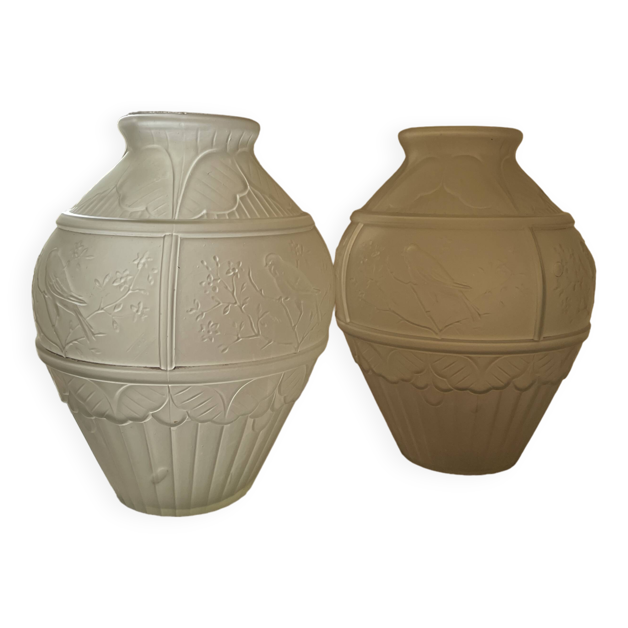 2 semi-opaque glass vases with relief bird designs.