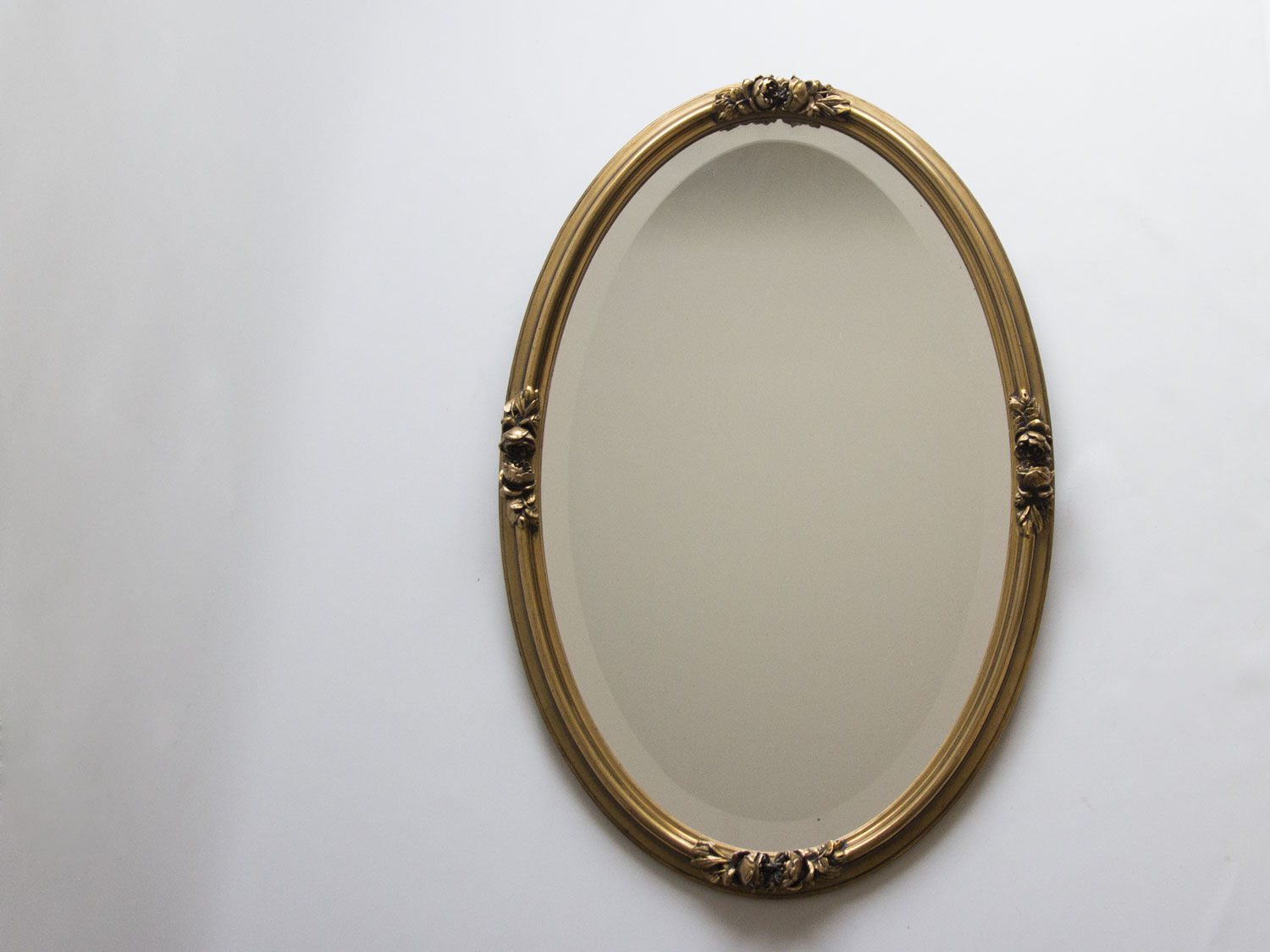 Golden oval mirror