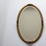 Golden oval mirror