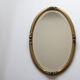 Golden oval mirror
